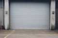 Roller door or roller shutter, concrete floor in industrial building i.e. modern factory, plant, warehouse, shop, garage or store Royalty Free Stock Photo
