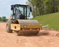 Roller packs highway ramp under construction