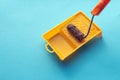 Roller For Paint And Painting Capacity On Blue Background Surface. Home Repair Creativity Concept Royalty Free Stock Photo