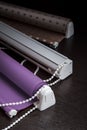 Roller and roman blind on the black wood background Royalty Free Stock Photo