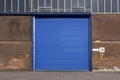 Roller shutter door and concrete floor outside factory building for industrial background Royalty Free Stock Photo