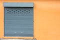Roller Shutter Door on Yellow Wall. Royalty Free Stock Photo