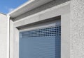 Roller shutter gate. Metal roller garage door as background. Automatic electric roll-up garage gate. Garage with blue rolling Royalty Free Stock Photo