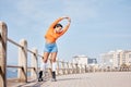 Roller skate, stretching and banner with a girl at the promenade on a blue sky background for the weekend. Fitness Royalty Free Stock Photo