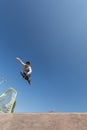 A roller skater jumps a ramp doing a trick in a skate park Royalty Free Stock Photo
