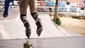 Roller skater jumping in a half pipe in an urban skate park Royalty Free Stock Photo