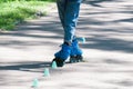 Roller skates on female legs close up. The girl deftly drives around the chips Royalty Free Stock Photo