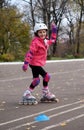 Roller skating  happy little girl in park rollerblading on inline skates. Caucasian girl in outdoor activities Royalty Free Stock Photo