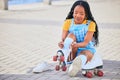 Roller skating, tie and safety with a black woman by the sea, on the promenade for training or recreation. Beach, sports