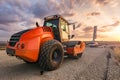 Roller smoothing a first layer of asphalt in the construction of a new road Royalty Free Stock Photo