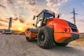 Roller smoothing a first layer of asphalt in the construction of a new road Royalty Free Stock Photo