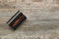 Roller with tobacco on old wooden table, top view. Making hand rolled cigarettes