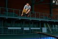 Rollerblader jump high from big air ramp performing trick. Indoors skate park equipment. Royalty Free Stock Photo