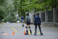 Rollerblading. Boys practicing in artistic slalom in a city park