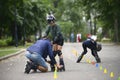 Rollerblading. Trainer corrects boy movements teaching of artistic slalom