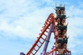 Rollercoaster with people riding along the track in the amusement park. Royalty Free Stock Photo
