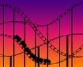 Rollercoaster silhouette on sunset sky background