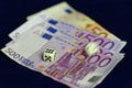 Rolling dice on sorted Euro banknotes Royalty Free Stock Photo