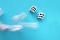 Rolling Dices over blue background. Casino gambling concept Royalty Free Stock Photo