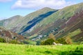 Rolling fells and valley in the Lake District with green fields in the summertime Royalty Free Stock Photo