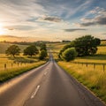 Rolling green fields and patches of trees under a partially cloudy sky, Royalty Free Stock Photo