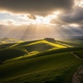 Hills under dramatic cloud cover with sunlight streaming through Royalty Free Stock Photo