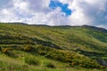 Rolling green hills in Wicklow, Ireland with blue sky and white fluffy clouds in summer. Royalty Free Stock Photo