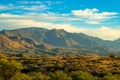 Rolling hills in the cliffs and ravines of arizona in wild west north american mountains and blue sky with puffy clouds