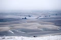 Rolling hills covered with frost and snow in winter.