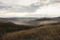 Rolling hills of tuscany region covered in morning fog Royalty Free Stock Photo