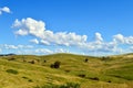 A rolling hillside with white clouds Royalty Free Stock Photo