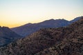 Rolling mountain hills in cliffs and ridges of tuscon arizona in afternoon sunset or early sunrise sun with haze sky Royalty Free Stock Photo