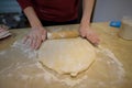 Rolling Out Dough on Floured Table Surface Royalty Free Stock Photo