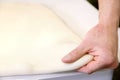 Rolling out dough by male hands at bakery Royalty Free Stock Photo