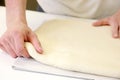 Rolling out dough by male hands at bakery Royalty Free Stock Photo