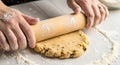 Rolling out dough with a rolling pin on a floured surface Royalty Free Stock Photo