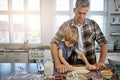 Rolling out the perfect pizza. a father and his son making pizza at home. Royalty Free Stock Photo