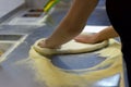 Rolling out pizza bases from dough with pizza hands Royalty Free Stock Photo