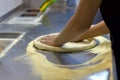 Rolling out pizza bases from dough with pizza hands Royalty Free Stock Photo