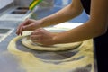 Rolling out pizza bases from dough with pizza hands Royalty Free Stock Photo