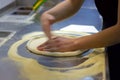 Rolling out pizza bases from dough with pizza hands Royalty Free Stock Photo