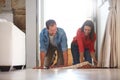 Rolling out some fun times together. a mature couple rolling out a carpet together at home.