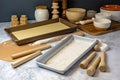 rolling pin, dough, and baking pans on the table for hands-on cookie baking workshop