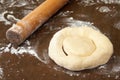 Rolling pin and raw dough prepared for donuts Royalty Free Stock Photo