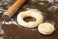 Rolling pin and raw dough prepared for donuts Royalty Free Stock Photo