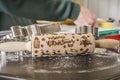 Rolling pin stamped with merry christmas, cookie cutters, and a baking pan on a table, closeup Royalty Free Stock Photo