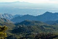 Rolling ridge hills in the cliffs of arizona wilderness in dry season desert with mountain and hazy blue sun skies