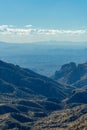 Rolling ridge hills in the cliffs and wilderness of arizona in tuscon with hazy cloud skies blue and shadow wilderness