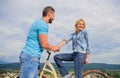 Rolling romance or bike date. Man with beard and shy blonde girl on first date. Woman feels shy in company with