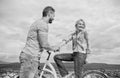 Rolling romance or bike date. Man with beard and shy blonde girl on first date. Woman feels shy in company with